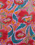 Colorful floral pattern with pink, blue, and orange colors on a red background
