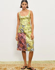 Woman wearing a floral dress with a plain background. Alamais Adriana Skirt