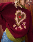Person wearing a Alemais Fredo Sweater. Sustainable Top. Knitwear. Heart design.