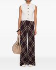 Person wearing a white sleeveless top and plaid pants with a beige bag on a white background. forte-forte cashmere wool English ribbed vest.