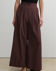 Brown wide-leg pants worn by a person on a plain background