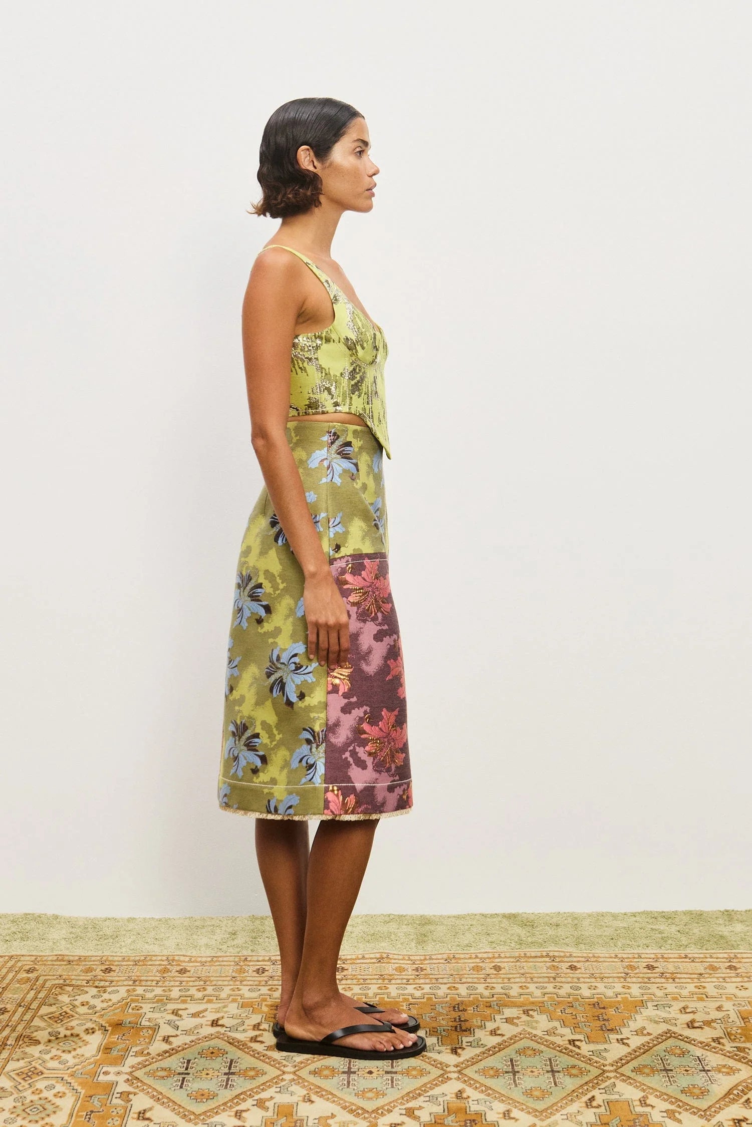 Woman wearing a floral skirt and top. Skirt is the Alemais Adriana Jacquard Skirt