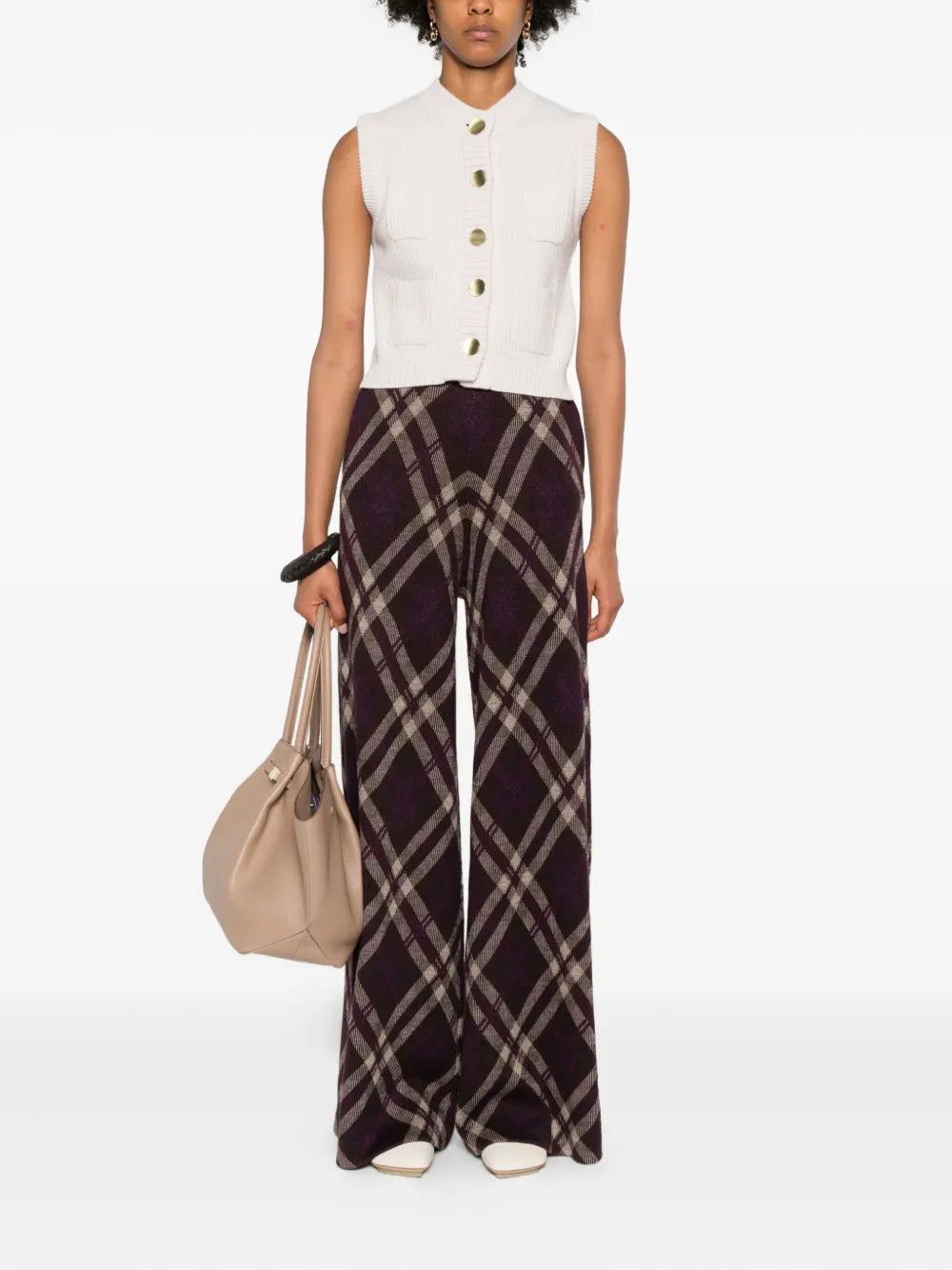 Person wearing a white sleeveless top and plaid pants with a beige bag on a white background. forte-forte cashmere wool English ribbed vest. 