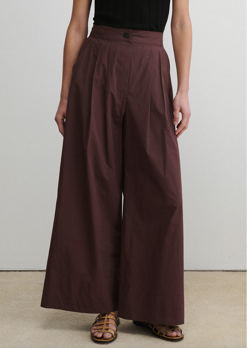 Brown wide-leg pants worn by a person on a plain background